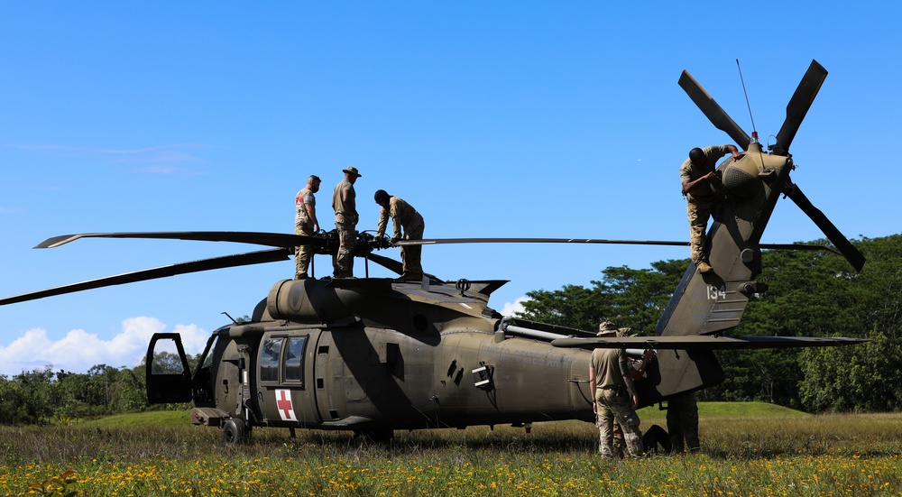 Soldiers perform end-of-flight maintenance on UH-60 Black Hawk helicopter