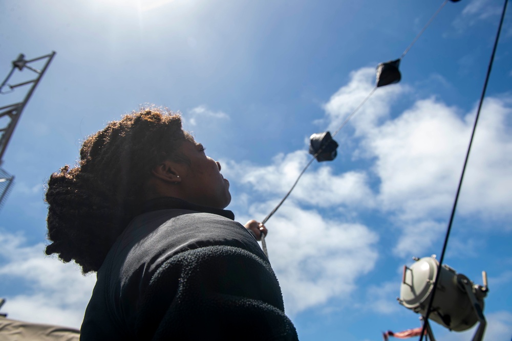 Sailor Hoists Flags