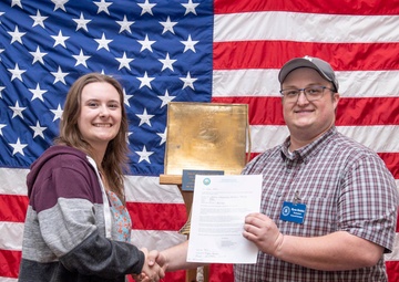 Tentative TRFB Hire Poses for Photo at Job Fair