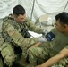 Soldier checks vital signs during Global Medic