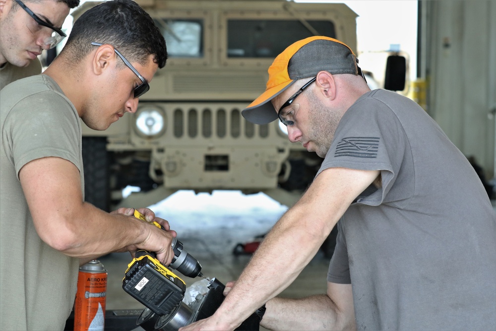 Mechanics from military police units turn wrenches