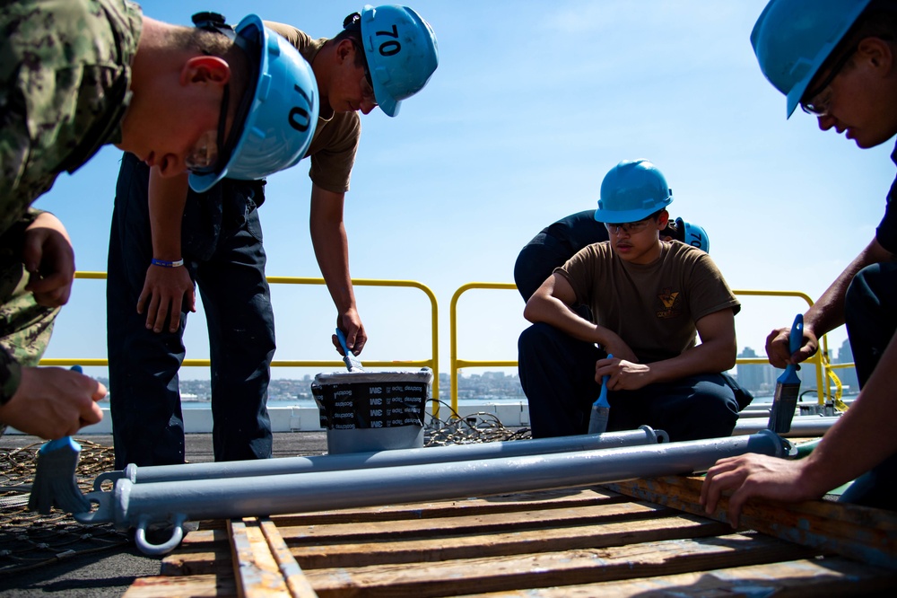 USS Carl Vinson (CVN 70) Sailor Paints Safety Net Brackets