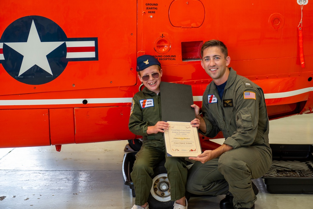 Coast Guard Aviation Training Center Mobile awards 7-year-old boy honorary aviator title