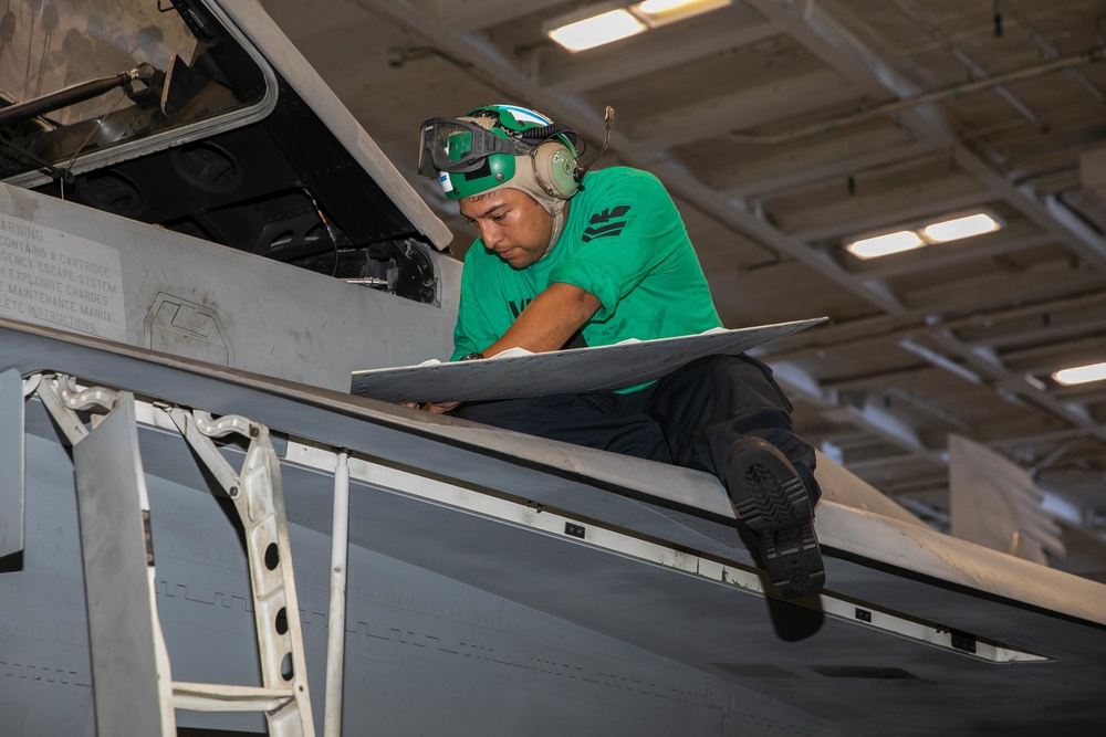 Strike Fighter Squadron (VFA) 143 Sailor Repairs Aircraft Aboard USS George H.W. Bush (CVN 77)