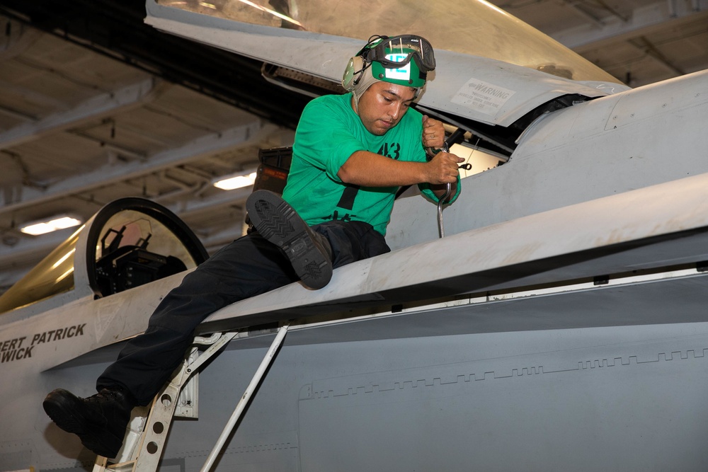 Strike Fighter Squadron (VFA) 143 Sailor Repairs Aircraft Aboard USS George H.W. Bush (CVN 77)