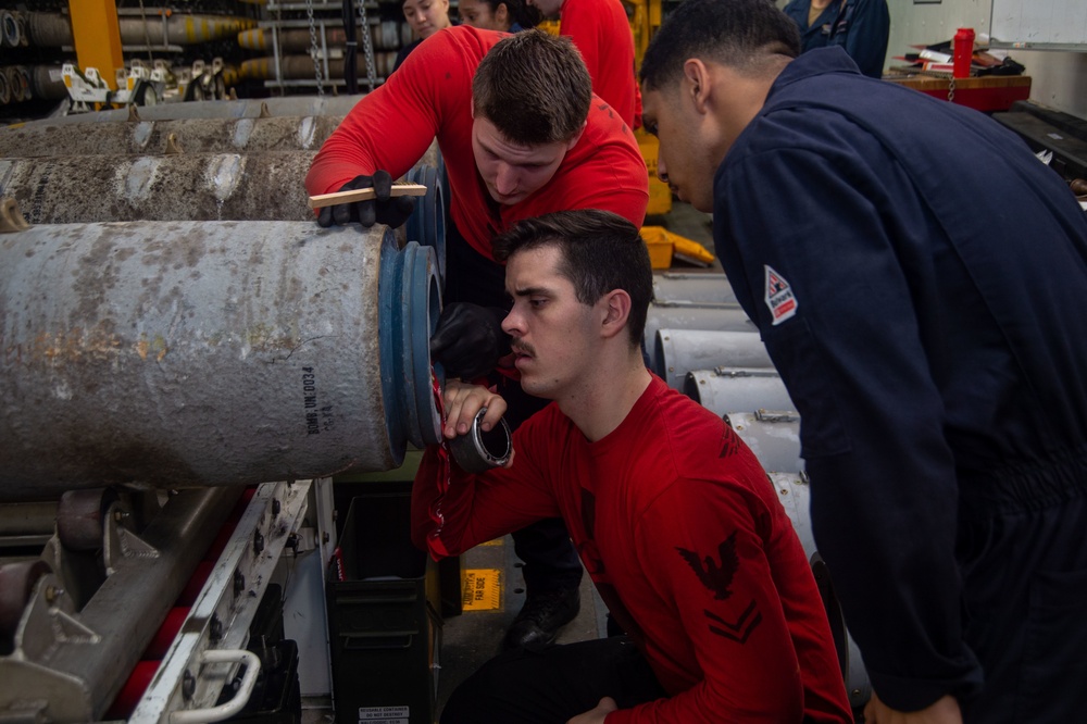 USS Ronald Reagan (CVN 76) Sailors assemble ordnance