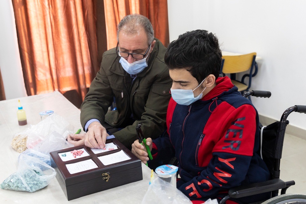 Abd Al Elah, left, is a Syrian refugee with disabilities and a handicraft instructor