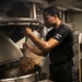 USS George H.W. Bush (CVN 77) Sailor Prepares Food