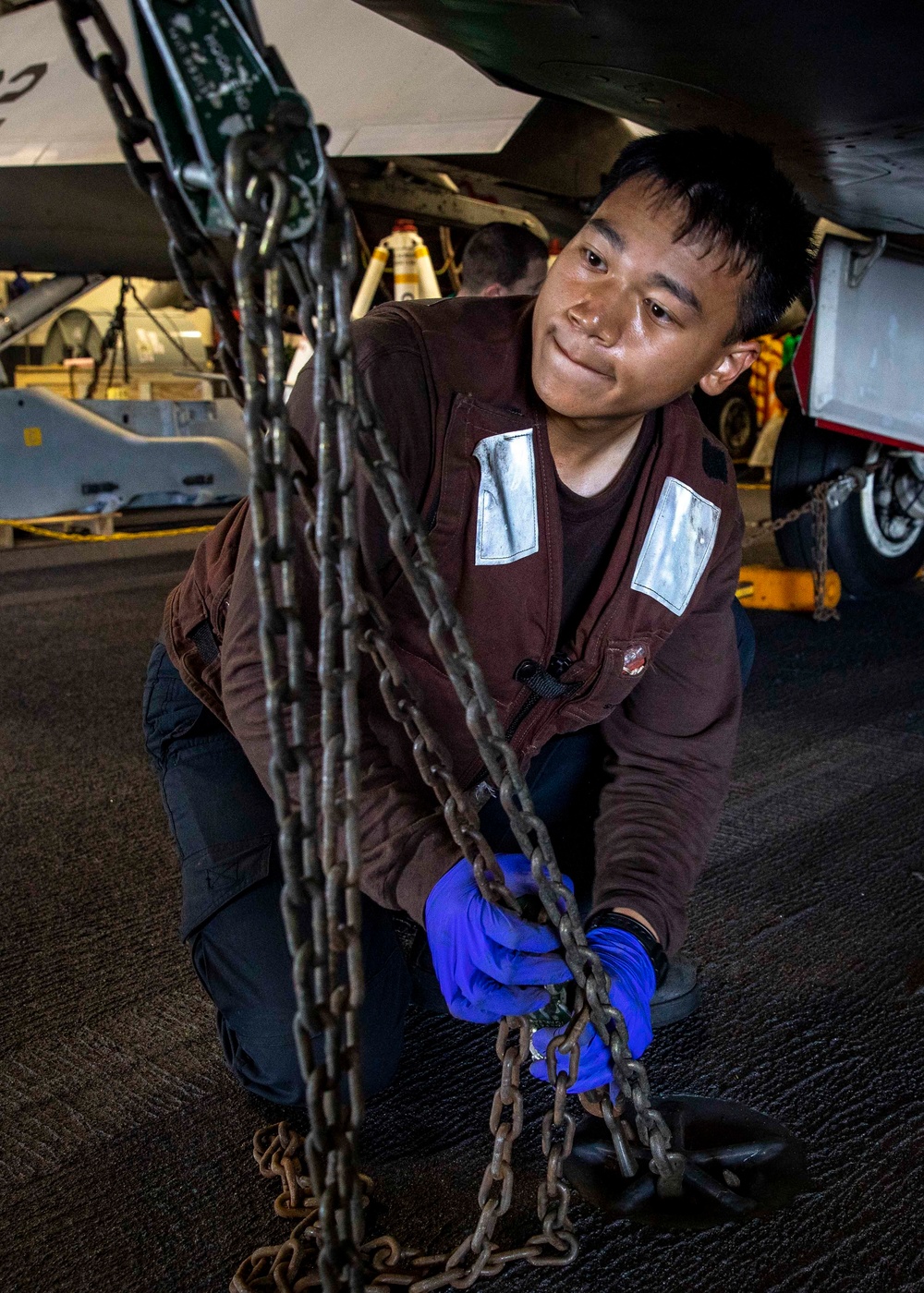 Strike Fighter Squadron (VFA) 136 Sailor Secures Aircraft Aboard USS George H.W. Bush (CVN 77)