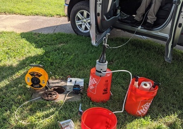 Environmental engineers monitor water quality through groundwater sampling