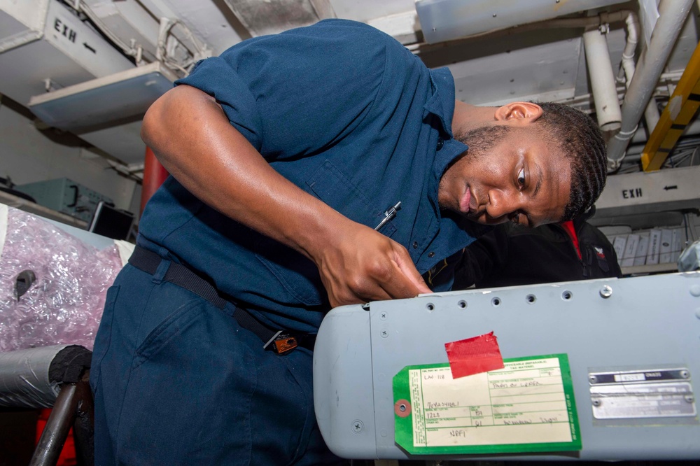 Sailor Removes Scews From Equipment