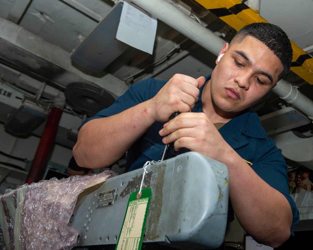 Sailor Removes Scews From Equipment