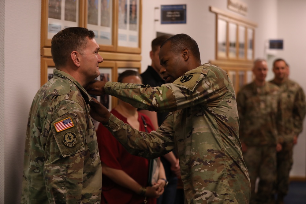 Col. James Brown is pinned with The Meritorious Service Medal by Maj. Gen. James Smith