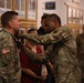 Col. James Brown is pinned with The Meritorious Service Medal by Maj. Gen. James Smith