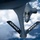 An aerial refueling operation is captured from the boom operator's perspective aboard a tanker aircraft. The tanker's refueling boom extends toward a B-1B Lancer strategic bomber approaching from below. The tanker aircraft bears 'OHIO ANG' markings on its horizontal stabilizers, identifying it as belonging to the Ohio Air National Guard.