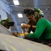 Abraham Lincoln Sailor conducts aircraft maintenance