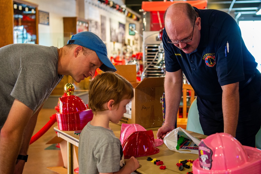 NSA Mid-South Fire Department speaks with families at The Fire Museum of Memphis during Navy Week Memphis