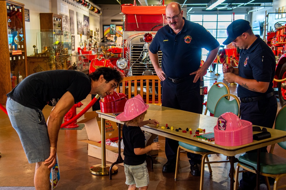 NSA Mid-South Fire Department speaks with families at The Fire Museum of Memphis during Navy Week Memphis