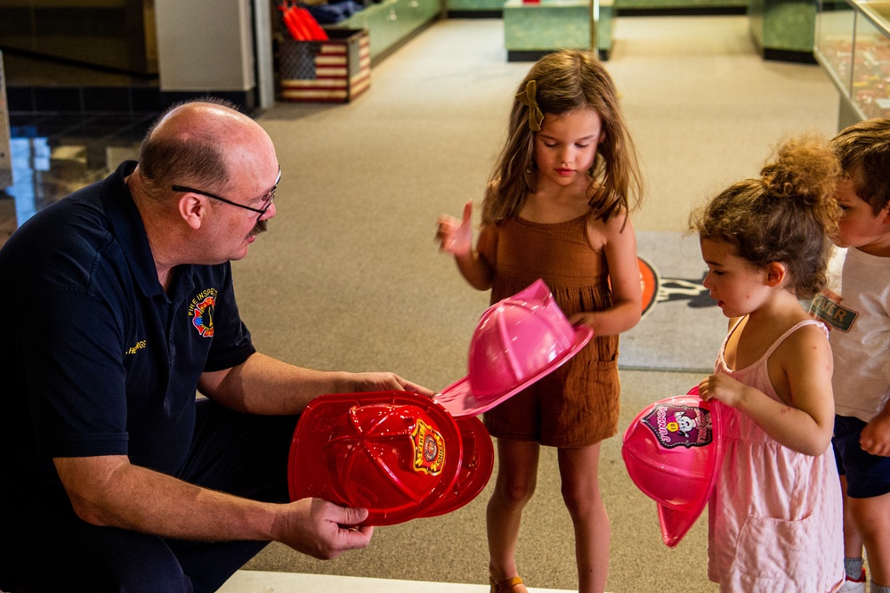 NSA Mid-South Fire Department speaks with families at The Fire Museum of Memphis during Navy Week Memphis