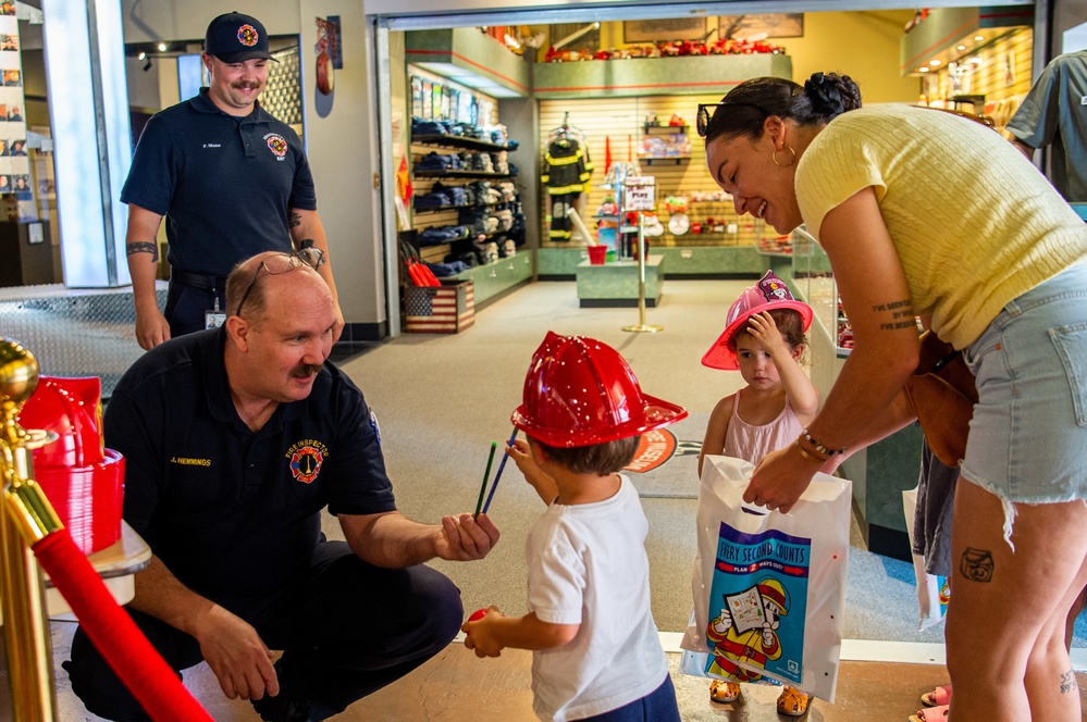 NSA Mid-South Fire Department speaks with families at The Fire Museum of Memphis during Navy Week Memphis