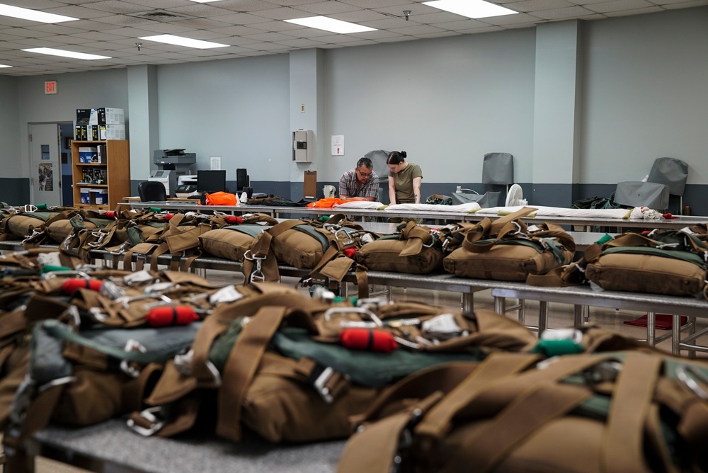 1 SOSS aircrew flight equipment specialists pack life-saving parachutes