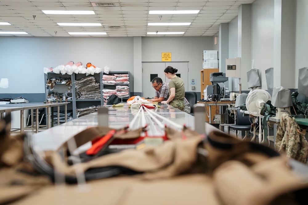1 SOSS aircrew flight equipment specialists pack life-saving parachutes