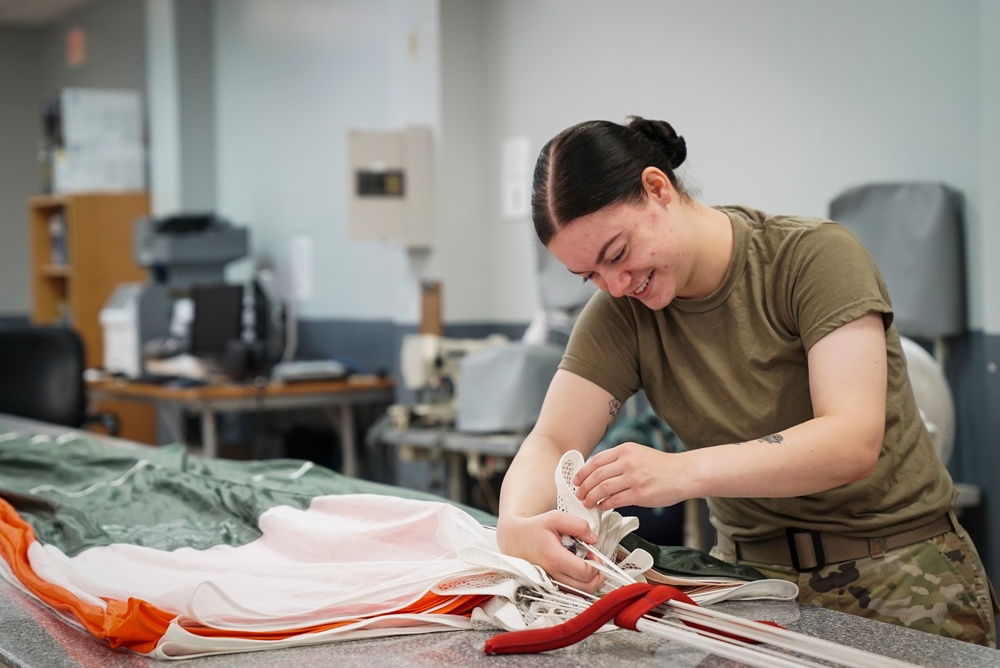 1 SOSS aircrew flight equipment specialists pack life-saving parachutes