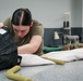 1 SOSS aircrew flight equipment specialists pack life-saving parachutes