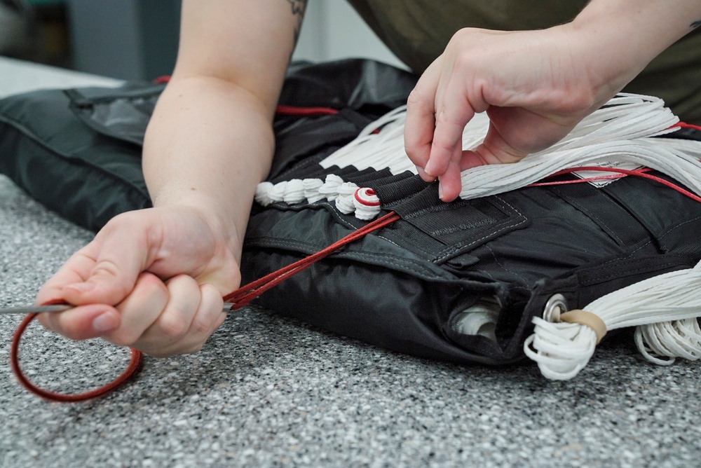1 SOSS aircrew flight equipment specialists pack life-saving parachutes