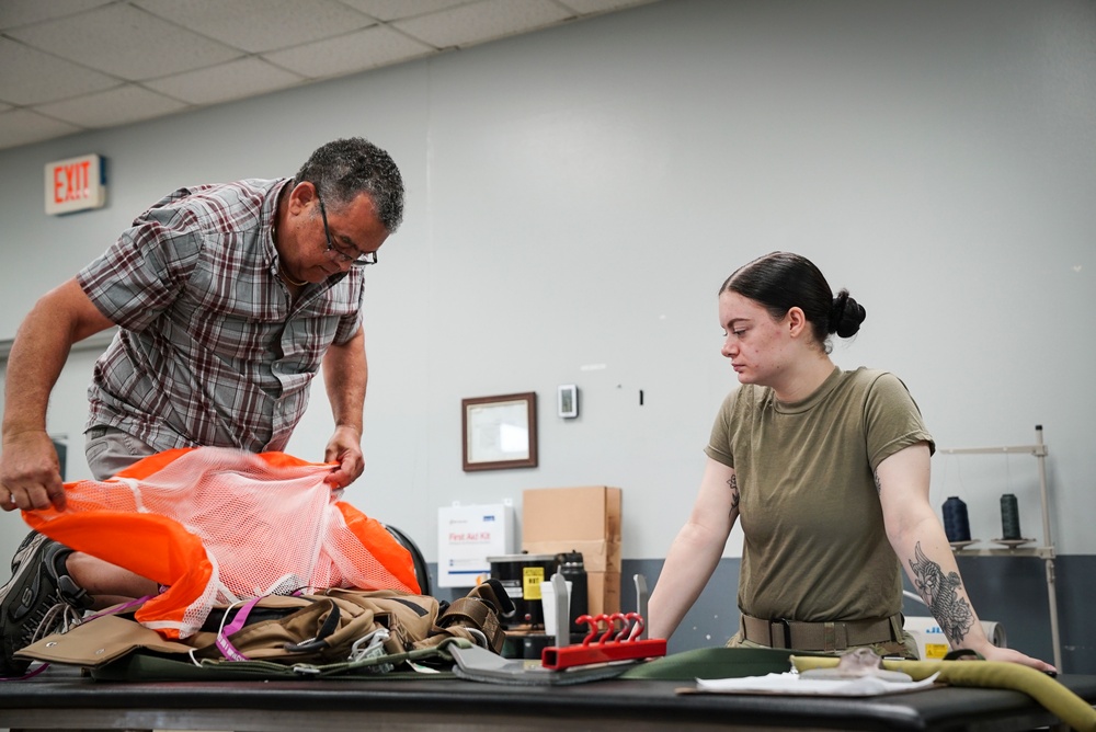 1 SOSS aircrew flight equipment specialists pack life-saving parachutes