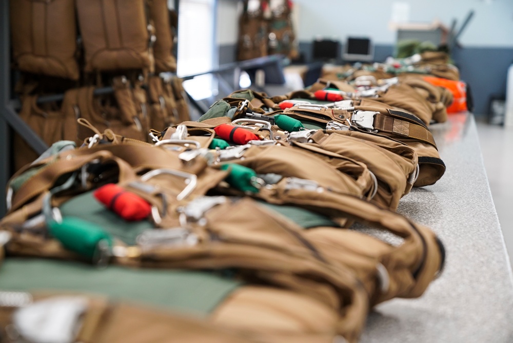1 SOSS aircrew flight equipment specialists pack life-saving parachutes