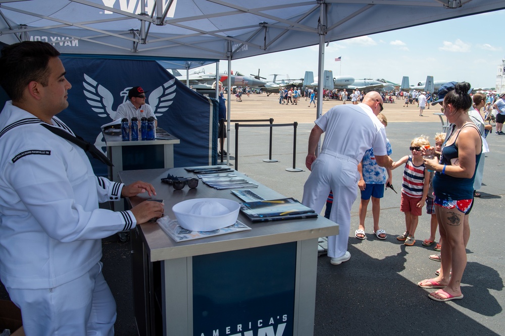 Sailors assigned to Navy Talent Acquisition Group (NTAG) Nashville and Talent Acquisition Onboarding Center (TAOC) Music City, talk to families about the Navy at the Midsouth Airshow during Navy Week Memphis