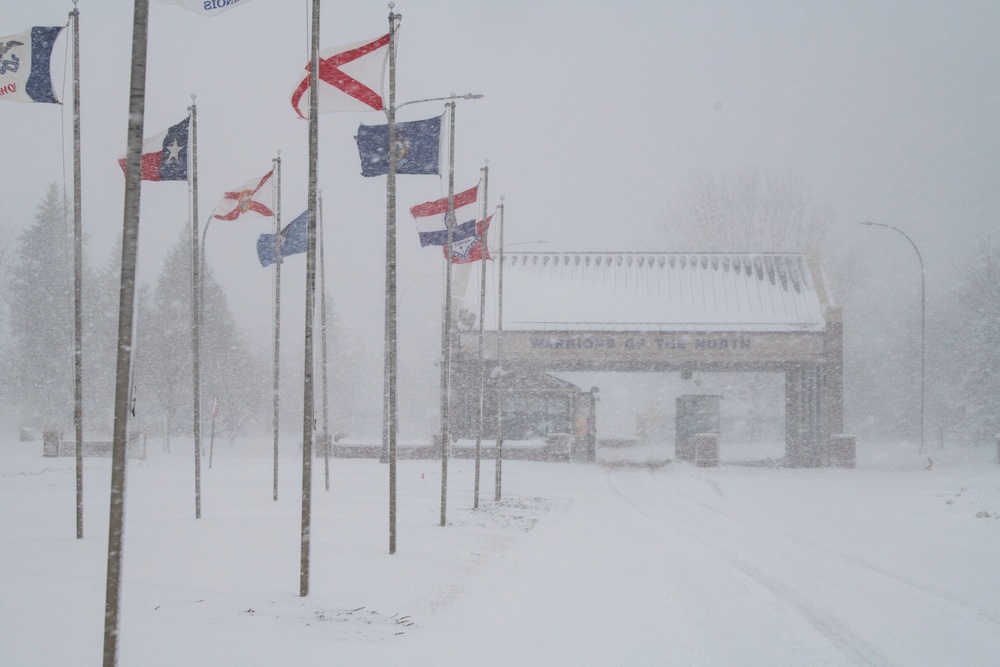 Grand Forks AFB main gate amidst spring blizzard