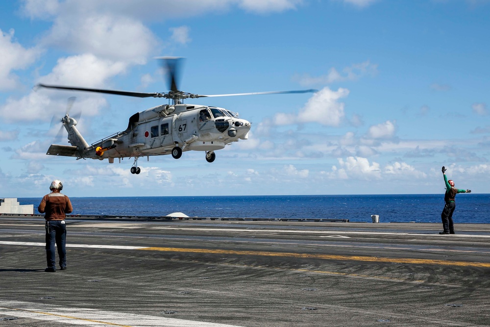 Japan Maritime Self-Defense Force SH-60K Seahawk helicopter lands aboard USS Abraham Lincoln