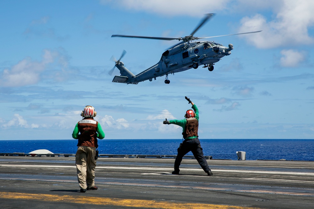 Royal Australian Navy MH-60R Seahawk helicopter lands aboard USS Abraham Lincoln