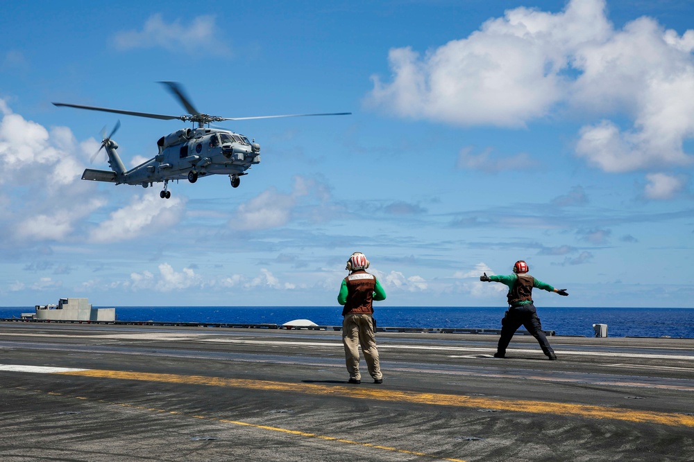 Royal Australian Navy MH-60R Seahawk helicopter lands aboard USS Abraham Lincoln