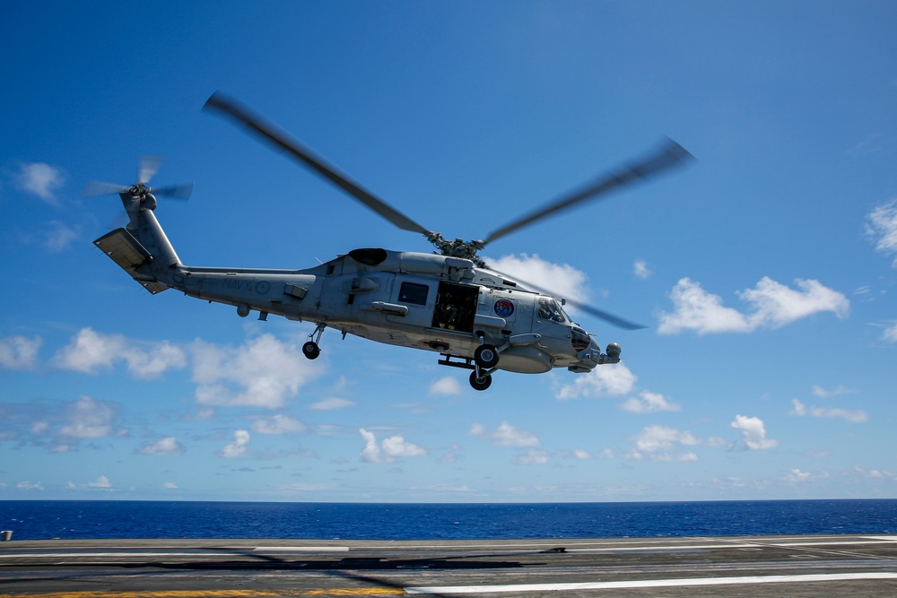 Royal Australian Navy MH-60R Seahawk helicopter lands aboard USS Abraham Lincoln