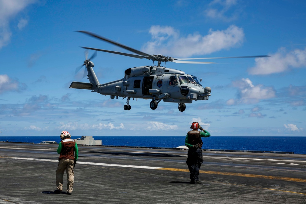 Royal Australian Navy MH-60R Seahawk helicopter lands aboard USS Abraham Lincoln