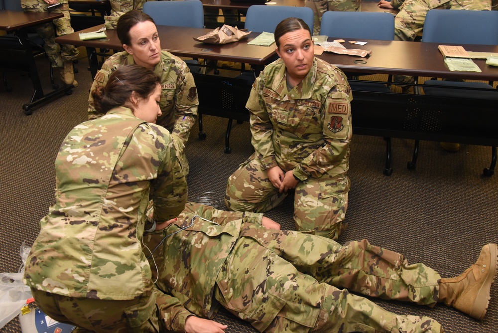 Airmen listen to code blue procedure instruction