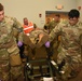 Airmen carry simulated gunshot victim in a litter