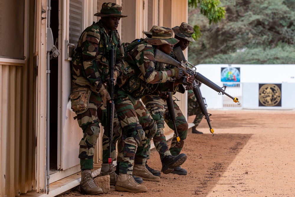 Senegalese Armed Forces soldiers move in formation to breach and clear a room during African Lion 22 in Dodji, Senegal