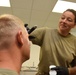 Sanchez applies makeup to an Airman