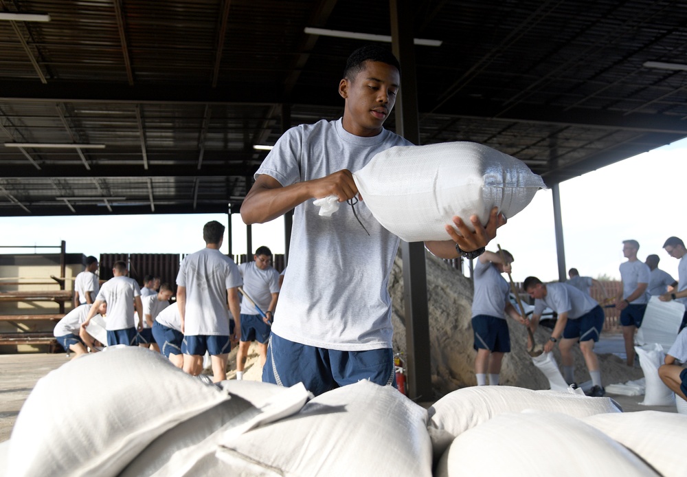 Airmen prepare sand bags for hurricane season