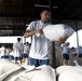 Airmen prepare sand bags for hurricane season