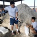 Airmen prepare sand bags for hurricane season