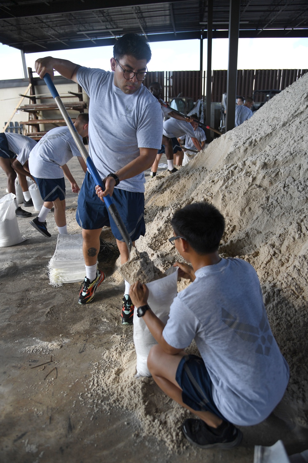 Airmen prepare sand bags for hurricane season