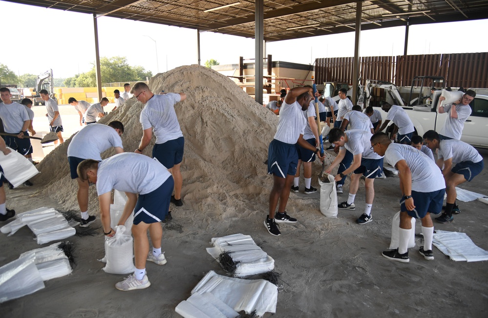 Airmen prepare sand bags for hurricane season