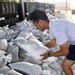 Airmen prepare sand bags for hurricane season