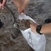 Airmen prepare sand bags for hurricane season