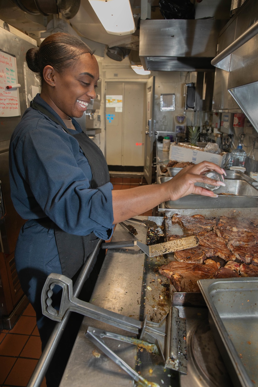 USS George H.W. Bush (CVN 77) Sailor Prepares Food